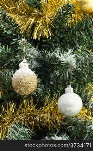 shiny christmas balls on christmas tree covered with snow