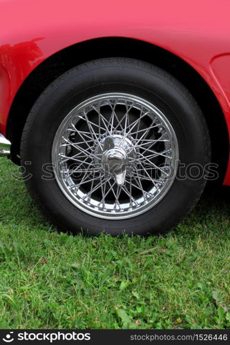 Shiny chromed spoke wheel of a classic sports car. Chrome wheel