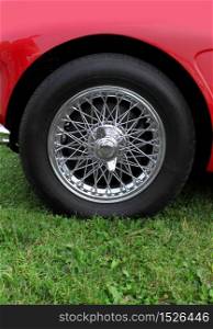 Shiny chromed spoke wheel of a classic sports car. Chrome wheel