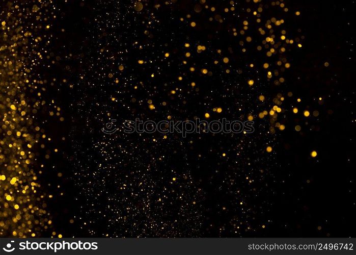 Shiny falling golden glitter dust background