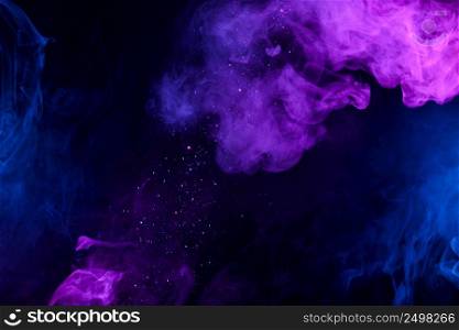 Shiny glitter falling in clouds of pink and blue smoke abstract background
