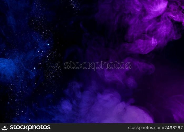 Shiny glitter in clouds of pink and blue fog smoke abstract background