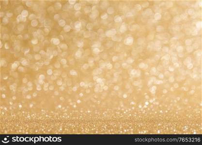 Shiny golden bokeh glitter lights abstract background, Christmas New Year luxury party celebration concept. Shiny golden lights background