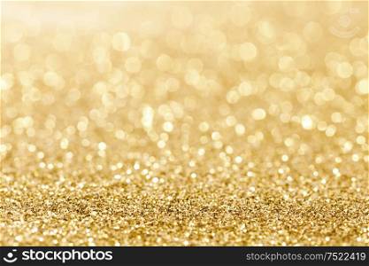 Shiny golden bokeh glitter lights abstract background, Christmas New Year party celebration concept. Shiny golden lights background
