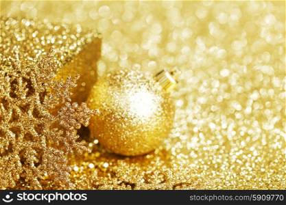 Shiny Golden christmas decor over glitter background