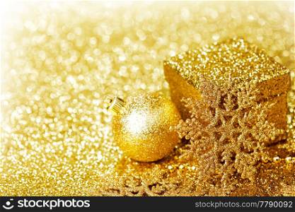 Shiny Golden christmas decor over glitter background