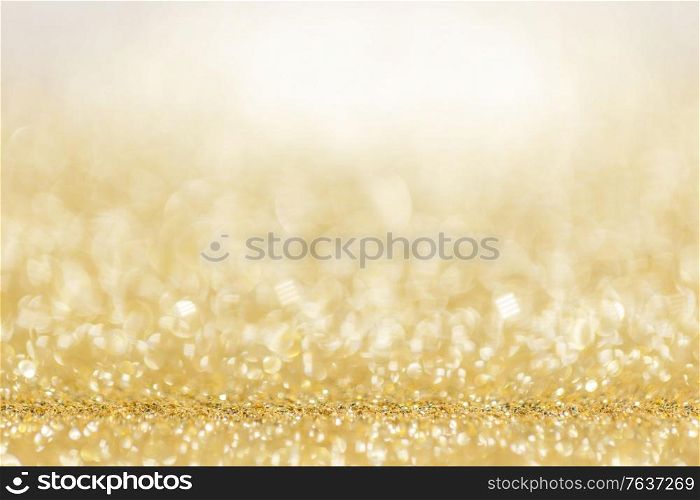 Shiny golden lights bokeh background Christmas New year celebration luxury party. Shiny golden lights background