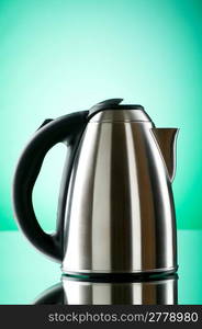Shiny kettle against the colorful gradient background