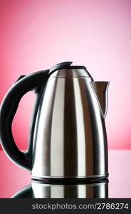 Shiny kettle against the colorful gradient background