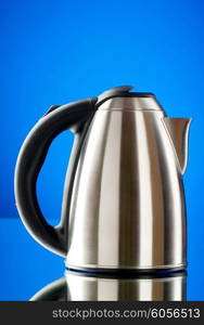 Shiny kettle against the colorful gradient background