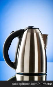 Shiny kettle against the colorful gradient background