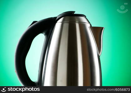Shiny kettle against the colorful gradient background