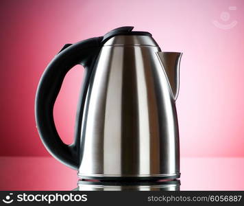 Shiny kettle against the colorful gradient background