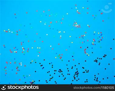 shiny multicolored round confetti scattered on a blue background, festive backdrop for birthday, valentines day. Festive decoration element. Flat design