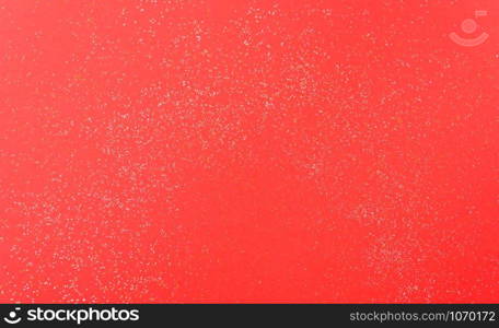 Shiny particles glitter on red background Christmas decorative with copy space