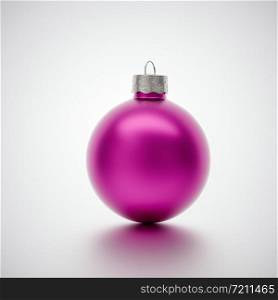 Shiny pink modern crimson Christmas bauble centered on a light grey background for seasonal Holiday celebrations and themes