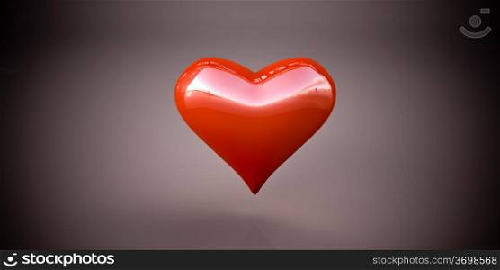 Shiny red heart on a dark gray background, vignetting