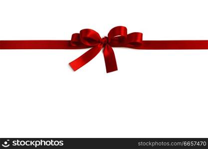 Shiny red satin ribbon and bow isolated on white background. Holiday gift concept. Shiny red satin ribbon bow