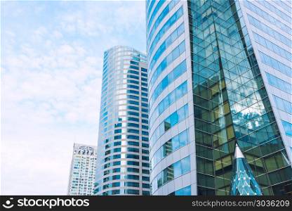 Shiny reflective business buildings and the blue sky with clouds