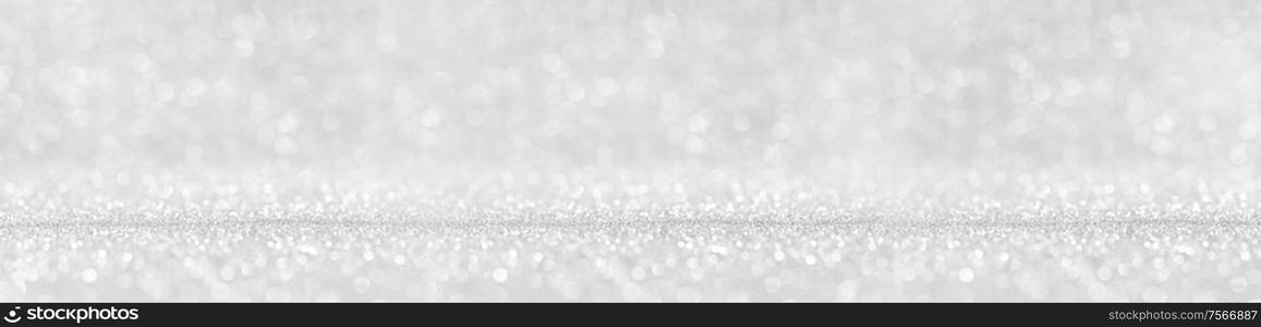 Shiny silver bokeh glitter lights abstract background, Christmas New Year party celebration concept. Shiny silver lights background