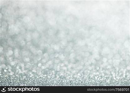 Shiny silver bokeh glitter lights abstract background, Christmas New Year party celebration concept. Shiny silver lights background