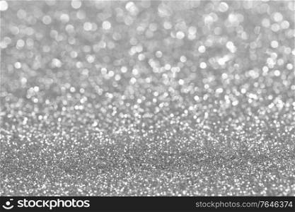 Shiny silver bokeh glitter lights abstract background, Christmas New Year party celebration concept. Shiny silver lights background