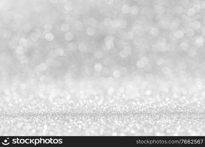 Shiny silver bokeh glitter lights abstract background, Christmas New Year party celebration concept. Shiny silver lights background