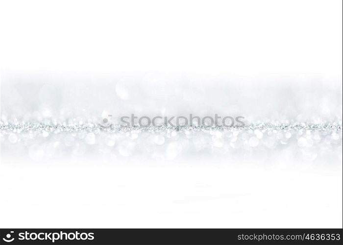 Shiny silver defocused glitter holiday background with white copy space