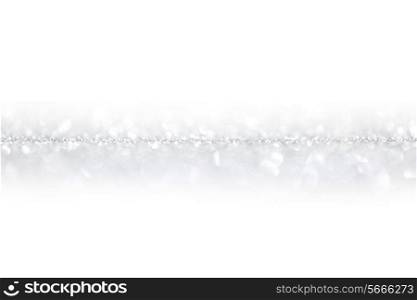 Shiny silver defocused glitter holiday background with white copy space