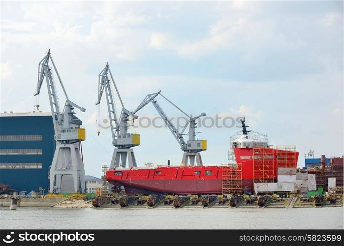 Ship being constructed and cranes
