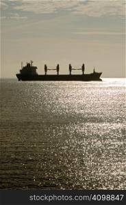 ship cruising on North Sea by sundown light
