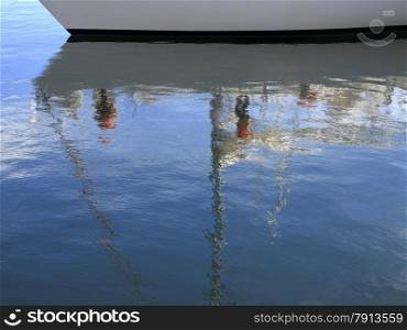 Ship detail in blue sea water with reflection. Yacht detail. Yachting