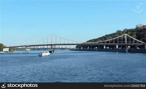 ship floats under Parkovy Bridge over Dnieper, Kiev, Ukraine