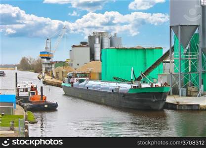 Ship in harbor of the cement plant. Netherlands