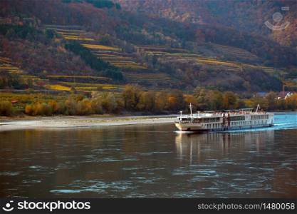 ship on the danube river. View of vineyards in sunset light, Wachau Valley, Austria