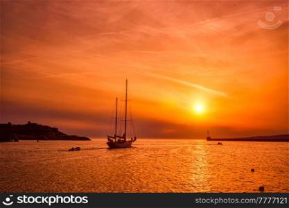 Ship schooner boat sihouette in port of Marseille on sunset. Marseille, France. Boat in port of Marseille on sunset. Marseille, France