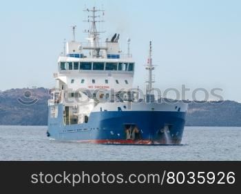Ship tanker in the Mediterranean Sea.. Small tanker on the raid of the island Santorini. Greece.