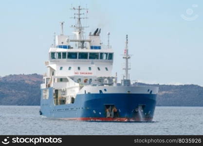 Ship tanker in the Mediterranean Sea.. Small tanker on the raid of the island Santorini. Greece.