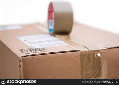 Shipping concept: Cardboard box and sticky tape