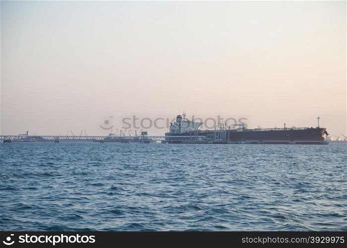 Shipping docks. Large cargo ship docked cargo to shore.