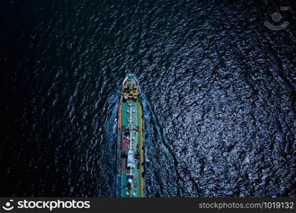 shipping loading oil tanker service import export international transportation business open sea at night aerial top view from drone camera