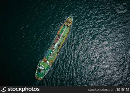 shipping oil tanker and petrochemical industry inport and export international by ocean at night time aerial view from drone camera
