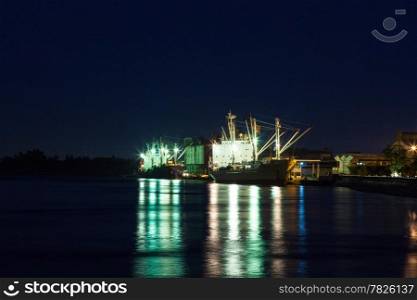 Shipping port at night. Cargo ship to dock at night.