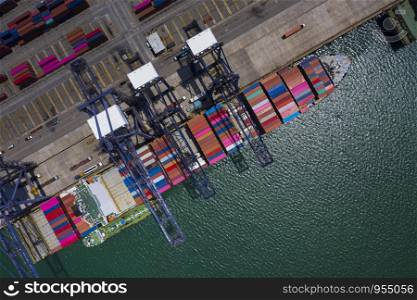 shipping port loading and unloading cargo containers logistics service station international shipping business by the sea vessel aerial view