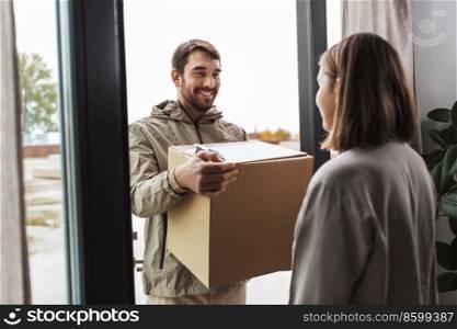 shipping, transportation and people concept - delivery man with parcel box and clipboard talking to customer at home. delivery man with parcel box and customer at home