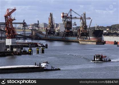 Ships being unloaded in the Port of Rotterdam in the Netherlands.