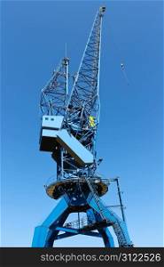 Shipyard crane against the blue sky