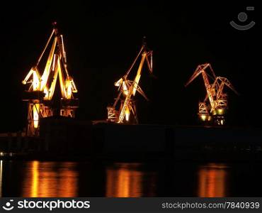 shipyard cranes illumination with reflection, night shot