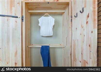 shirt and pants in wooden wardrobe