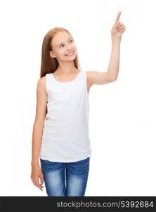 shirt design concept - smiling teenage girl in blank white shirt pointing to something or pressing imaginary button